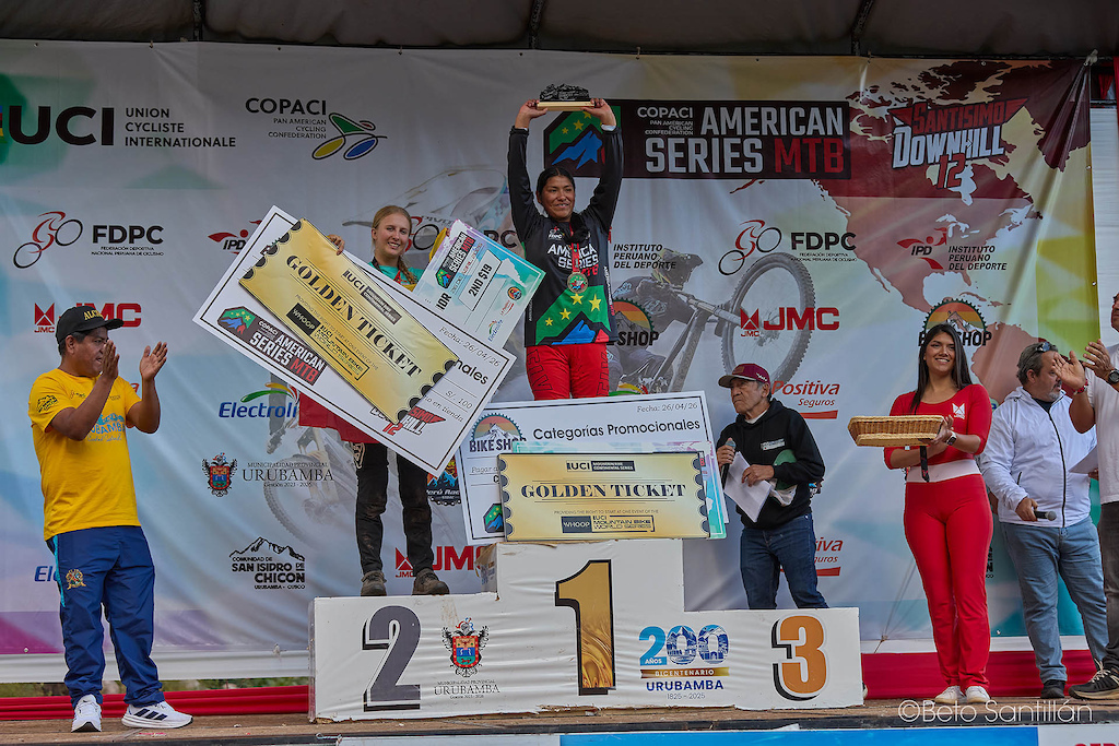 Mercedes Aquino from Peru rises to the very top of the Junior Women podium at Santísimo Downhill 12, lifting her trophy high and earning the most coveted prize in continental mountain biking — the UCI Golden Ticket, granting her direct entry to a UCI Mountain Bike World Series event. Beside her, Ecuador's Siena Josephine Reitz claims a brilliant second place and her own Golden Ticket, proving that Junior women's downhill in South America is producing world class talent. Two young riders. Two Golden Tickets. One unforgettable day on the mountain at the COPACI American Series MTB, Urubamba - Cusco, Peru. The future of downhill is female and it is arriving fast