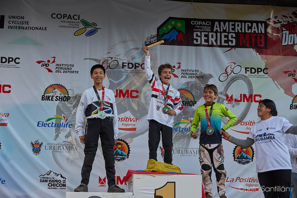 The future of downhill is here and it is absolutely fearless! Mateo Cárdenas from Ecuador erupts with pure joy on the top step of the Sub 13 podium at Santísimo Downhill 12, trophy raised high above Chicón, Urubamba - Cusco. Peru's Tadeo Seminario delivers an outstanding second place, while his compatriot Matías Rey rounds out the podium with a beaming smile in third. These young riders just conquered one of South America's most demanding downhill tracks — and they are only just getting started. Watch out for these names. The next generation has arrive