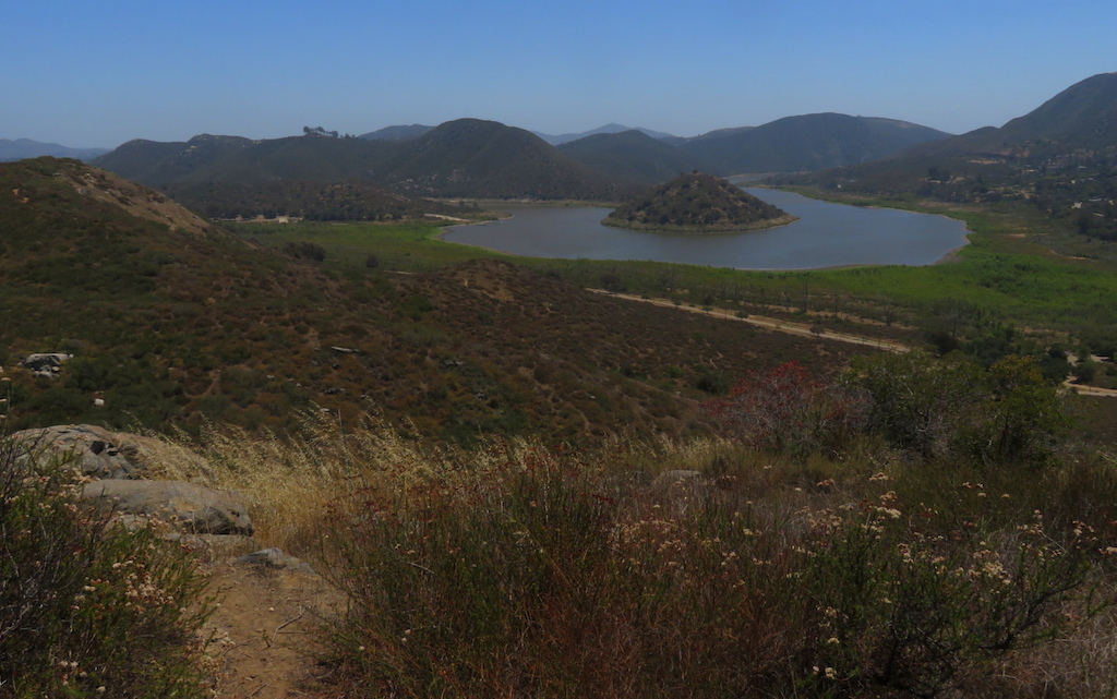 An expansive view of Lake Hodges with surrounding hills and green valley.