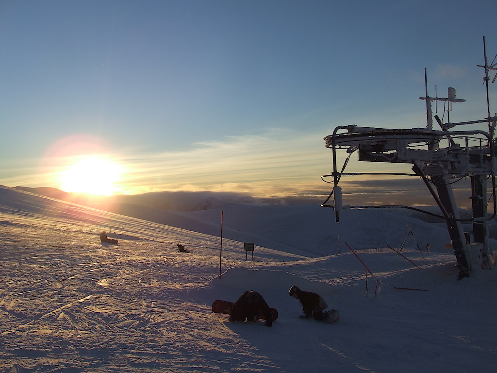 Pictures of the mountain, people skiing, the sun and the mountain being worked on getting it ready for the next day
