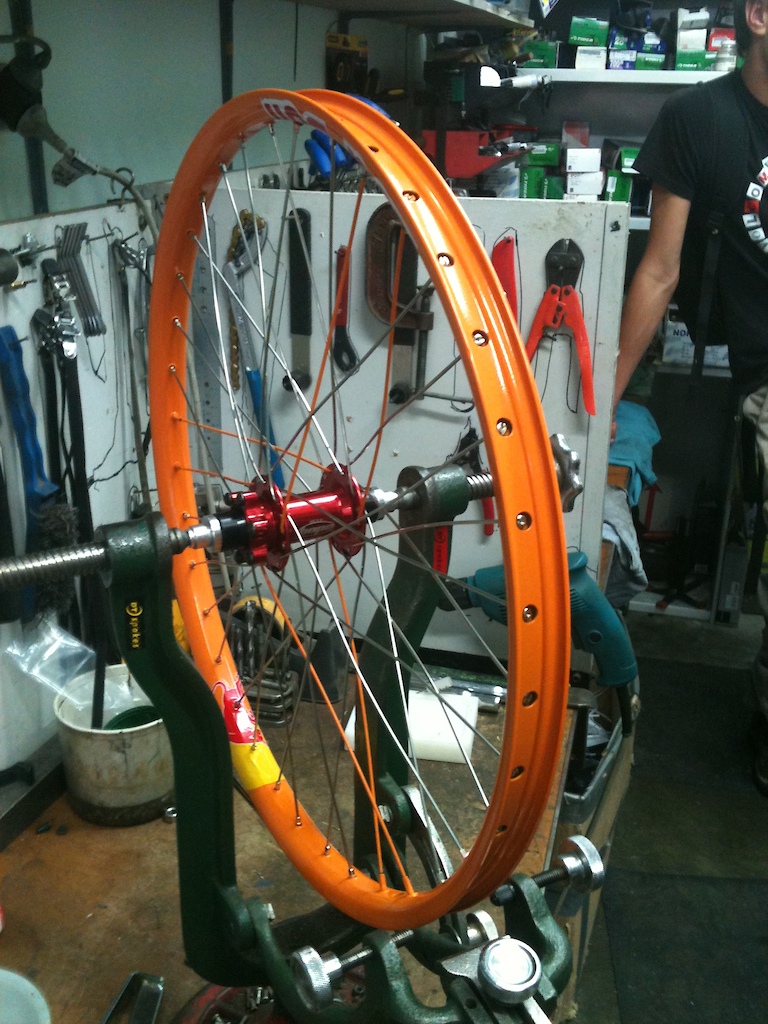Getting all laced up with $2 Dollar each dt swiss spokes with a sought of peace simble orange spoke pattern.