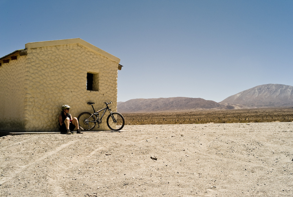 Despite its 2850m/9400 ft altitude, riding in Argentina's Los Cardones Park means getting up early to avoid the midday heat. This desolate cabin was the only shade for miles, providing a short breather.

Photo by Dan Milner