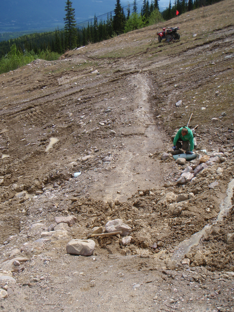 trying to recover a dry bike trail on a saturated ski run