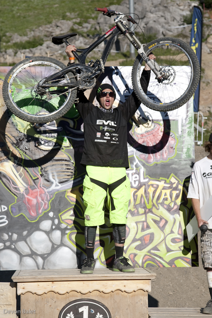 A stoked Cam Zink holds his carbon Evil proud.