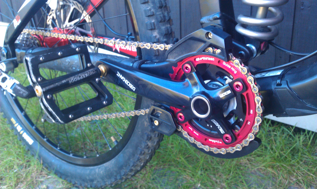 Close up of the Truvativ Descendant crank with e13 G-Ring, Nukeproof Ti-Mag pedals, e13 LG1+ chaingiude and KMC X9SL chain.