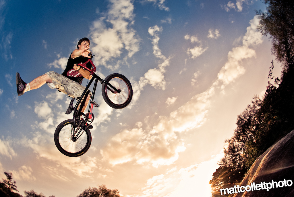 Hitting the dirt jumps with perfect lighting for photography. Fisheye, with off camera flash.