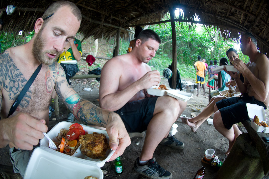 Seb Kemp and the other riders dig into some amazing mid ride food prepared on the beach by Rastaman Natty Grant and his crew.