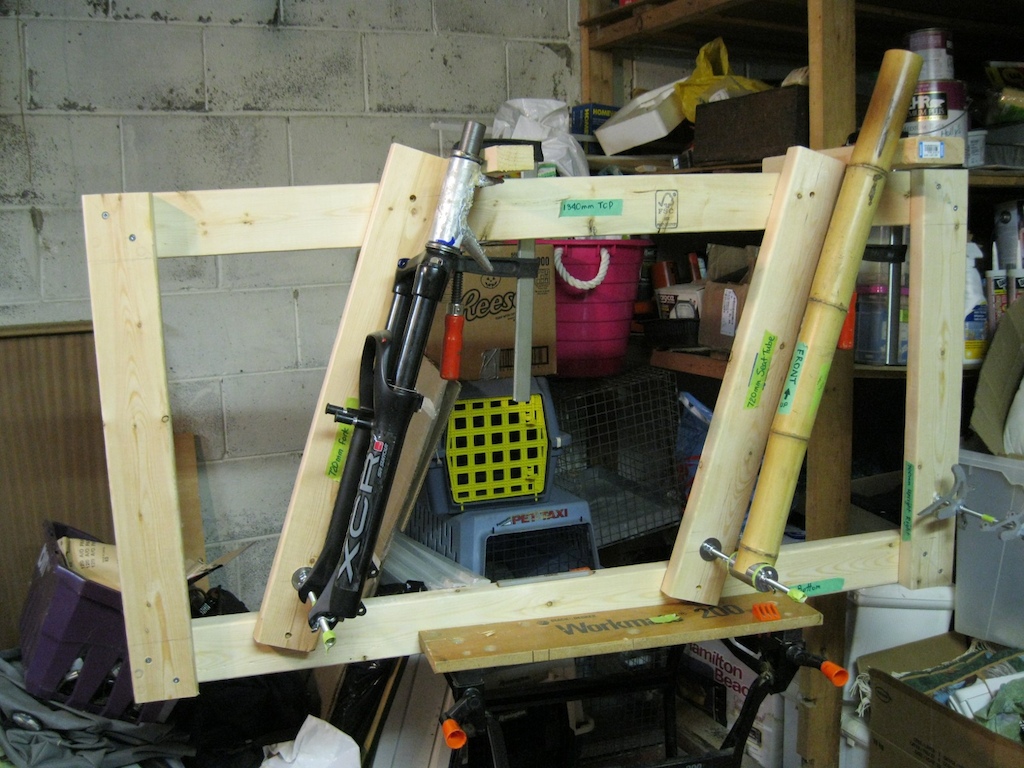 Bamboo bike frame jig built using 2x4s - side view, first cut piece in place.