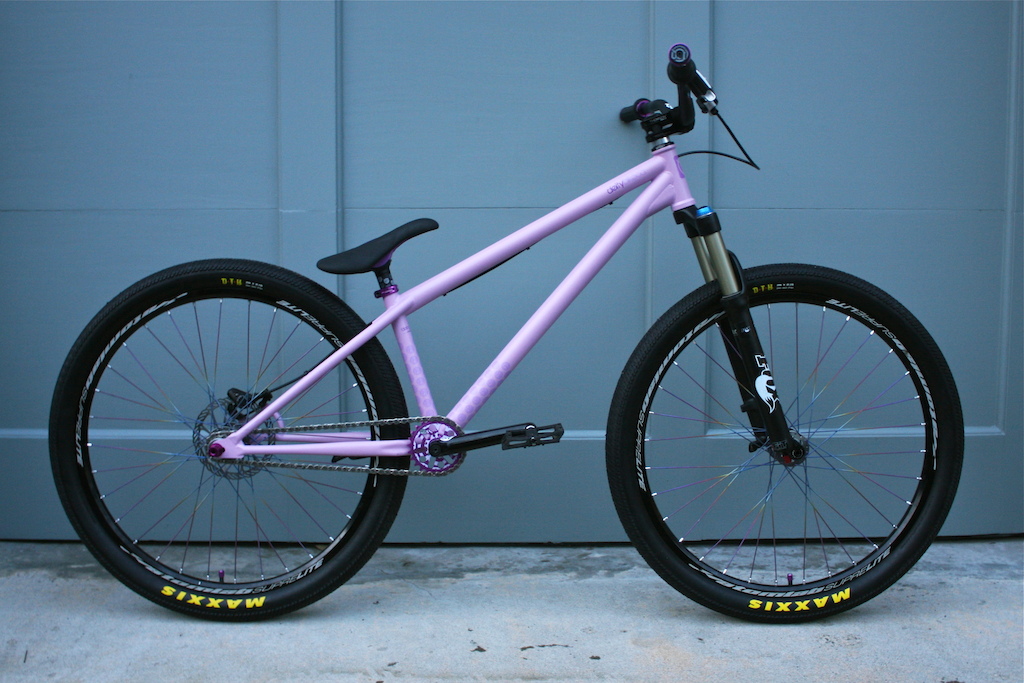 Frame: Flat purple deity streetsweeper
Fork: 2010 Fox 831 (non kashmia) at 100mm
Seat: Purple deity tekstyle (no bumpers)
Seatpost: Black deity pyston
Wheelset: 2010 Atomlab superlight wheel set with titanium spokes. 
Crank Arms: Deity vendetta 3 in black 170mm
Spindle: Deity 153mm ti
Sprocket: purple deity termite
Bb: Deity spanish armada in purple (19m)
Chain: KMC 710 SL in chrome
Pedals: Premium Slim PC in black 
Valve caps: Deity crown in purple
Seat clamp: Deity Cinch in purple
Bars: Deity topsoil in black
Brake: 2010 Shimano Xt with a 160mm Avid Cleansweep G3 
Stem: Thomson x4 elite in black
Grips: Deity enkoi with purple collars
Headset: Odyssey zero stack integrated in black
Tires: Maxxis DTH 2.15 kevlar with giant maxxis logo
Tubes: Maxxis Ultra light Schrade valve.