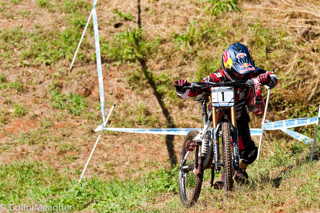 Aaron Gwin hikes back up the course in practice at the Pietermaritzburg UCI World Cup DH