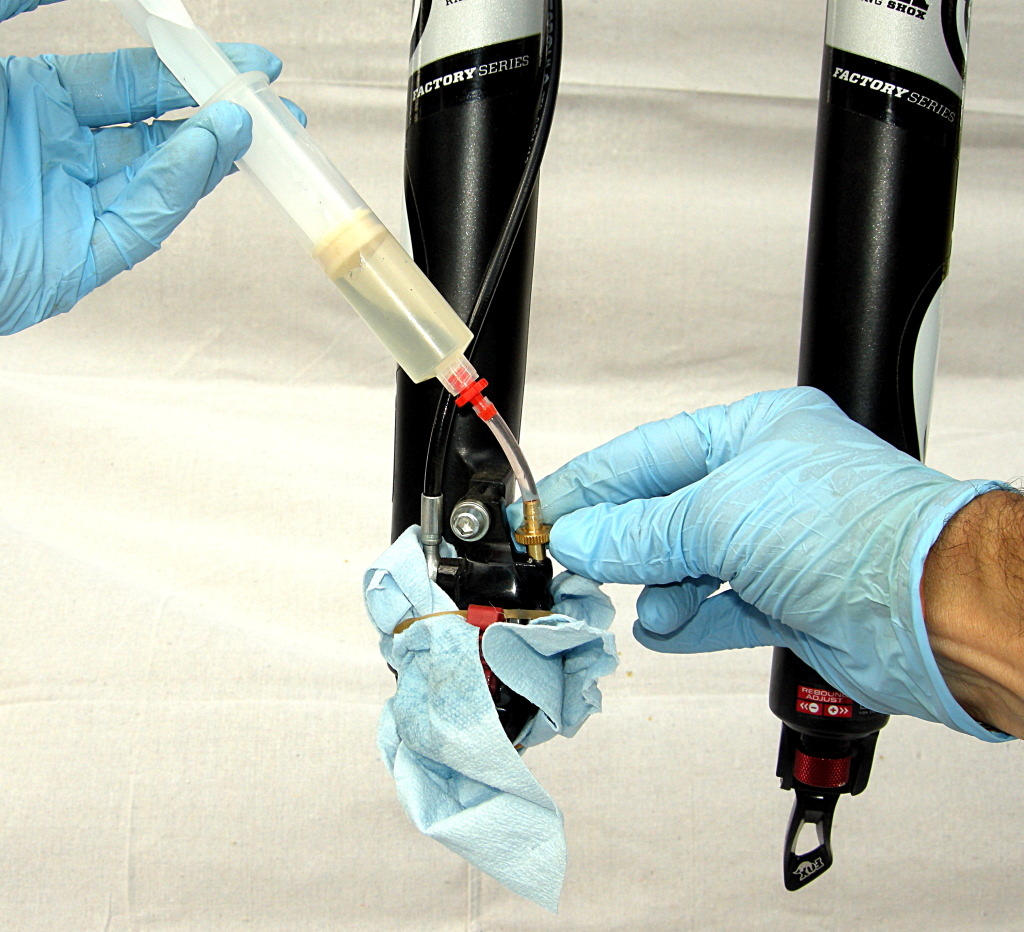 Remove plug and insert syringe fitting