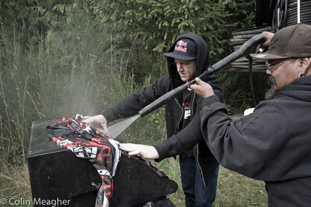 Gwin and Monkey getting the TWR logo sparkling white again with the pit row pressure washing machine.