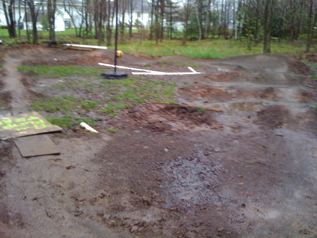 My pump track. Notice the tether ball for even more fun.