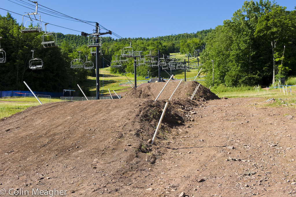 The track saw a bit of a make-over from Mother Nature and the Windham trail building crew. Mother Nature sent a Hurricane up the Eastern US Seaboard and Windham received record rainfall. The track up high is now littered with slate rock. At the bottom there s the old box drop into a berm and now a couple of proper big jumps. Clear this one and you re home free the finish line is a mere 30 meters from the transition.