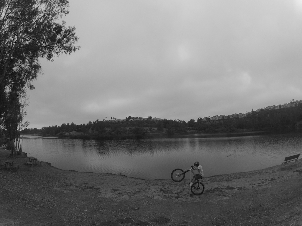 wheelie on my huge bike by a lake