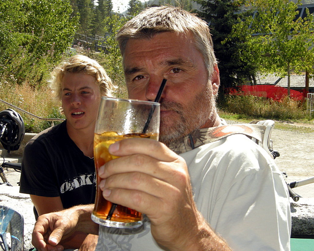 Lift your glass for  this man. Tom 'Pro' Prochazka takes a break with trail-builder Jesse Sanders. Tom Pro first managed the Whistler bike park and was instrumental in developing the trail system. Tom now heads Gravity Logic - the most respected trail design firm in the world.