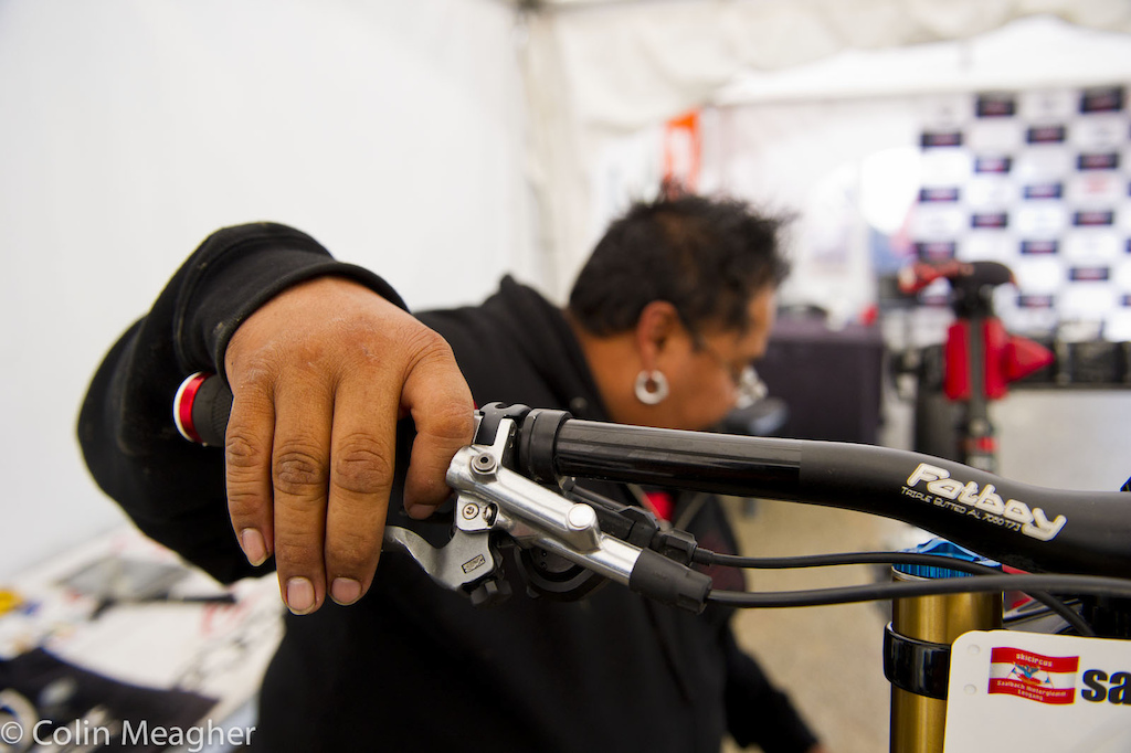 Monkdawg workling over Gwin s brakes first thing this morning before practice started. Official word is that the prototype brakes Gwin s been using since last winter failed after a some hard cornering--Shimano engineers are tearing into the brakes to determine what went wrong. These are prototypes though not production so the guts are a bit different than what everyone else is running. Gwin was offered the production brakes as soon as they became available but favored the feel of the prototypes over the production versions my guess is that he will be on production brakes in Norway for World Cup Finals.