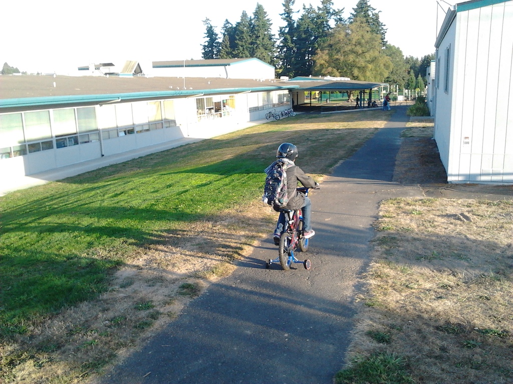 Proud of my daughter today- she rode her bike all the way to school today. Her first! Now, don't forget she has Dyspraxia which is a balance disorder, her hand-eye cordination is needing work- hence the training wheels. SHe powers that bike right along. STOKED!