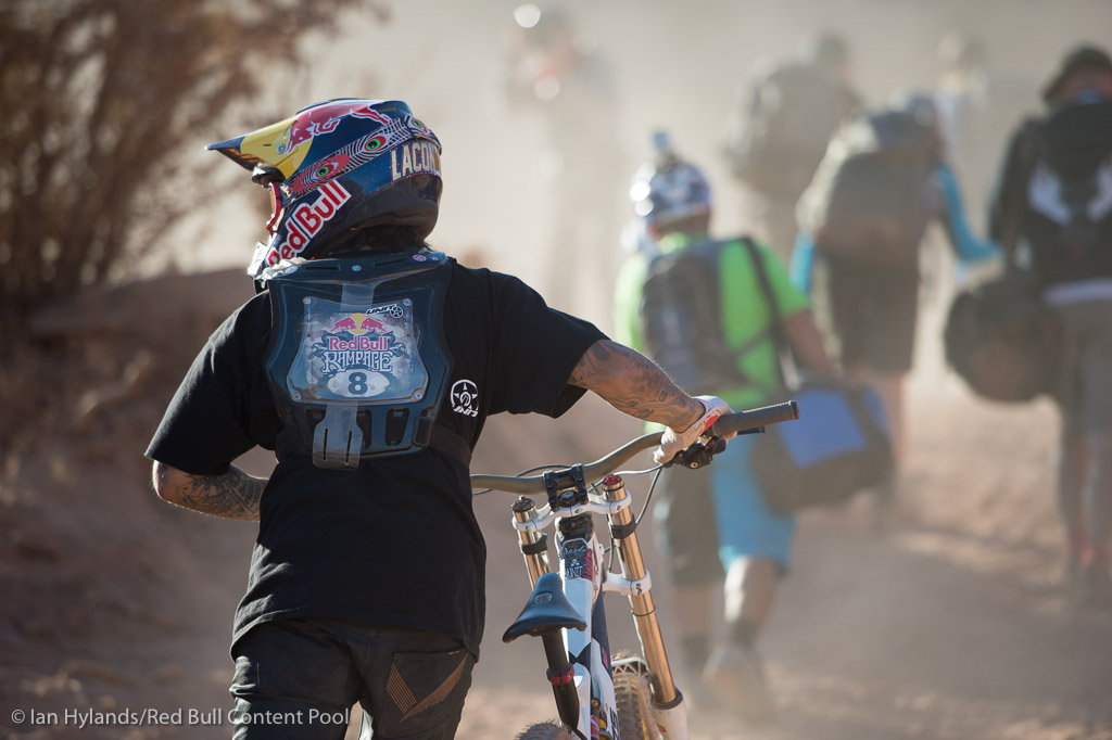 Andreu Lacondeguy pushes his bike up the hill at Red Bull Rampage in Virgin Utah on 7 October 2012