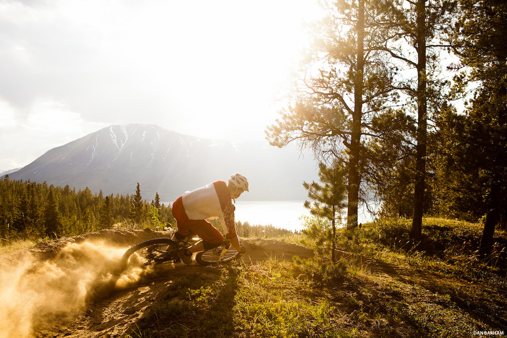 Sam Reimer kicks up a cloud of dust while cornering his mountain bike in Carcross, Yukon, Canada