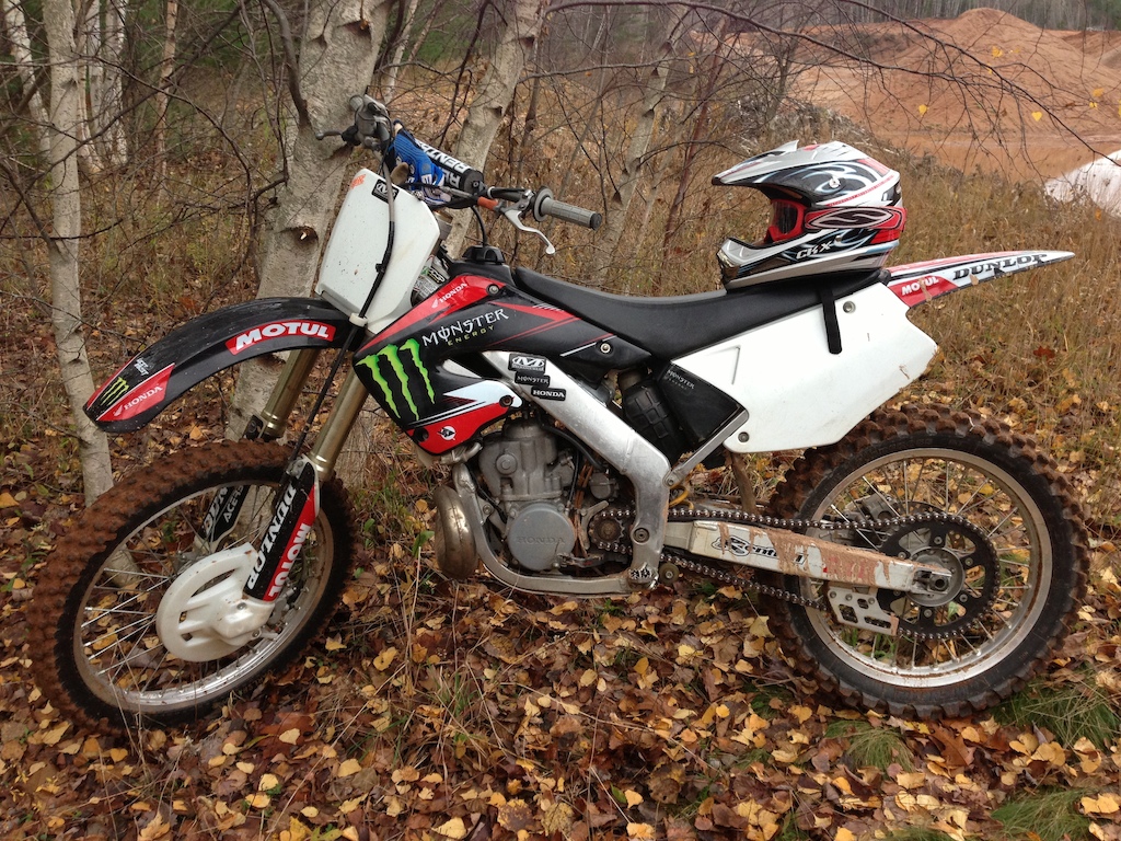 My Honda CR 250. At a pit, with a little dirt on her.