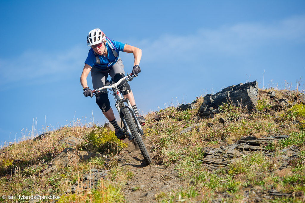 Lindsey Voreis rides her bike in the Alpine above Retallack Lodge near Kaslo BC