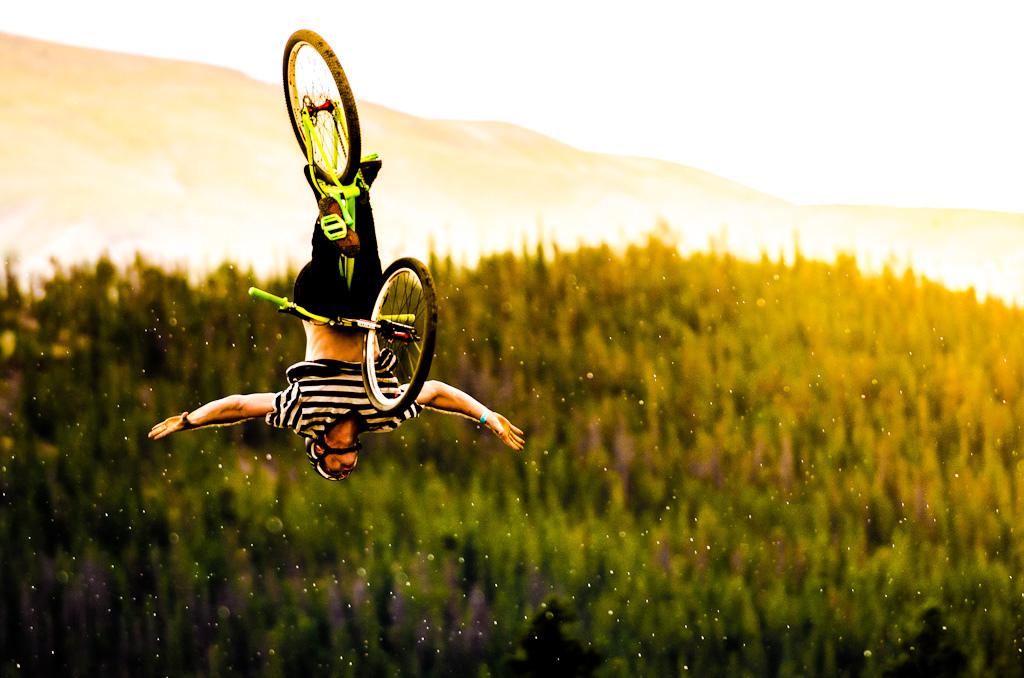 Back flip no hander during a rad sun shower during slopestyle practice at the Colorado Freeride Fest.