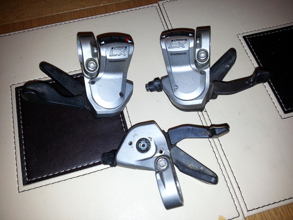 Shimano LX shifters. Left one dual release, the other two single release.