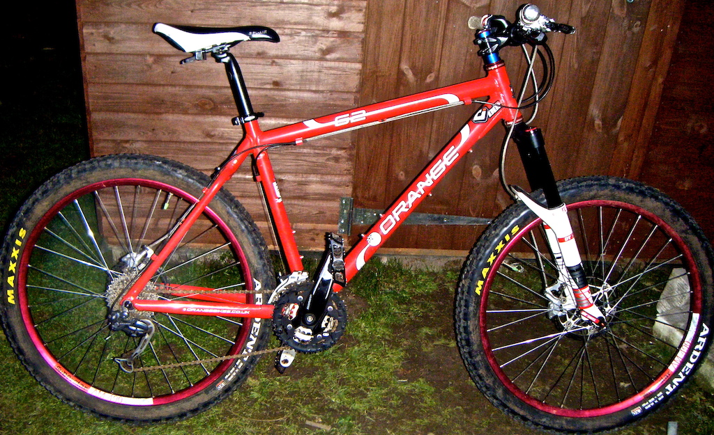 you all right heres my orange g2 got it standard as an xc. in which i race it now for AM and xc pretty good on short dh courses swell with a 130mm fork on it
heres my spec
Frame:6061 double butted aluminium G2
Fork: DT Swiss EXM130 Launch control 15mm
Headset:Hope Stainless steal
Spacers:Hope
Stem:Hope Fr
Bars:Supercross + by orange bikes
Grips:Odi Troy lee designs and odi bar end plugs
Seatclamp:Hope Qr 31.8
Seatpost:Stalk by orange bikes
Saddle:SDG Bel-Air
Brake F:Hope M4 180mm Floating at the front 
Brake R:Hope X2 160mm Floating on stoping duty at the rear
Wheels:
Front: 
Rim:Superstar AM409
Spokes:Sapim AM silver
Hub:Superstar Switch evo 15mm axle
Rear:
Rim:Superstar AM409
Spokes:Sapim AM silver
Hub:Superstar Tryzoid 120 pawls DH 9mm axle
Gearing:
Cranks:Shimano Deore Hollow tech on one side and Shimano Alivio octal ink on the other dont ask me how it works Pedals:BBB Freeride
Shifters:Shimano Alivio
Leads:Jagwire
Front mech:Shimano Alivio 3sp
Rear mech:Shimano Deore Shadow 9sp
Casette:Shimano Deore
Chain:Shimano XTR
Tires:
Front:Maxxis Ardent 2.25
Rear:Maxxis Ardent 2.25