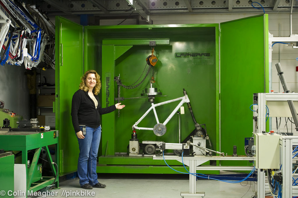 Every company that manufactures bikes or bike components has a slew of medieval torture devices on hand to make certain that each item that bears the company name meets or exceeds international standards of strength, durability, and safety. Liliana Morgado, head of Lapierre's safety testing, showing off the crowning glory of Lapierre's medieval bike testing devices. This machine has no name, really.  It's sole job is to test a frame for strength and durability up to and then beyond the international standards--essentially testing to what is considered "safe" for the public and then to failure to see how much margin of safety there is. Frames are selected at random from each batch to arrive from Lapierre's over seas production facilities and then put to the test on this rack. The test? Slamming a measured force against the frame in imitation of the load a rider would put on thef frame. Rinse and repeat.
