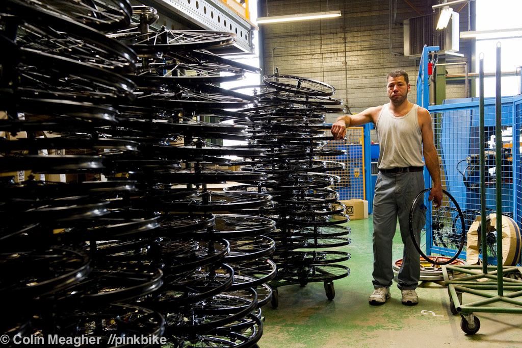Wheels--unless they are pre-built wheels from companies like Easton, Mavic, etc--are made in-house at Lapierre's facility. Here, Paolo de Souso, a ten year employee at Lapierre stands next to wheels he's assembled.