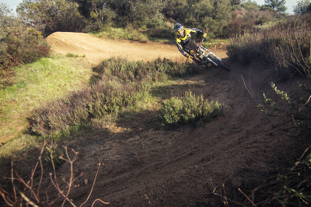 Luca Cometti digging deep and destroying a Pine Valley berm aboard his Nukeproof shred sled!