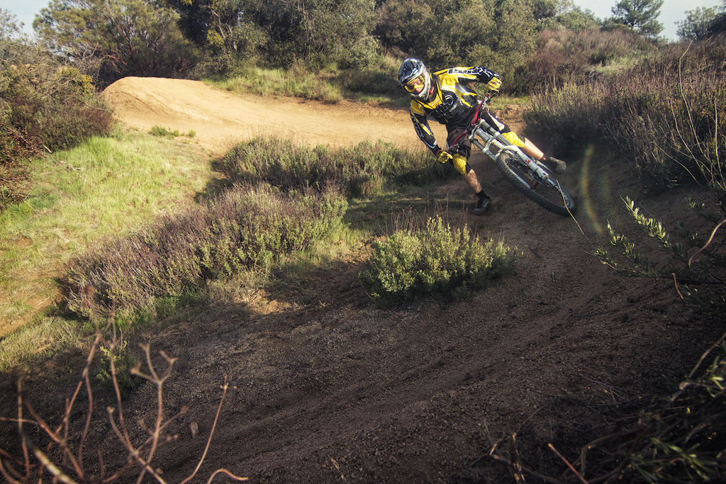 Luca Cometti digging deep and destroying a Pine Valley berm aboard his Nukeproof shred sled!
