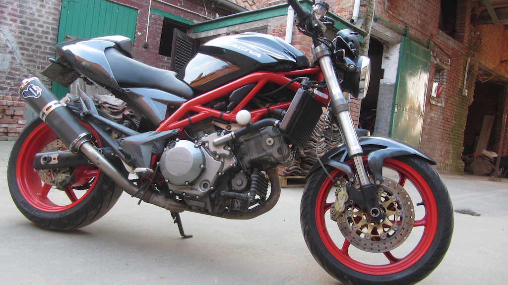 cagiva raptor 1000
red frame and wheels 
custom termignoni exhaust system
full carbon kit
and lots more