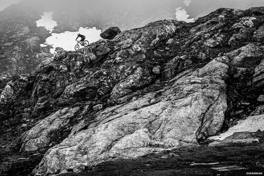 Linus Sjöholm rides his mountain bike down a rocky alpine ridgeline, Ãre, Sweden