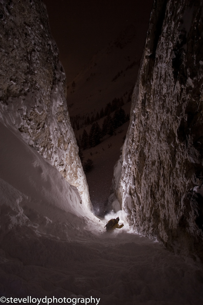 Jeff campbell skiing down a couloir at night.