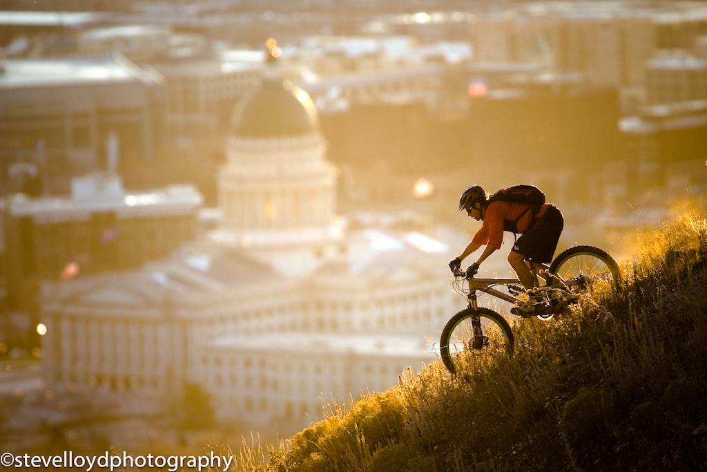 Josh Rhea rides past the Utah state capital