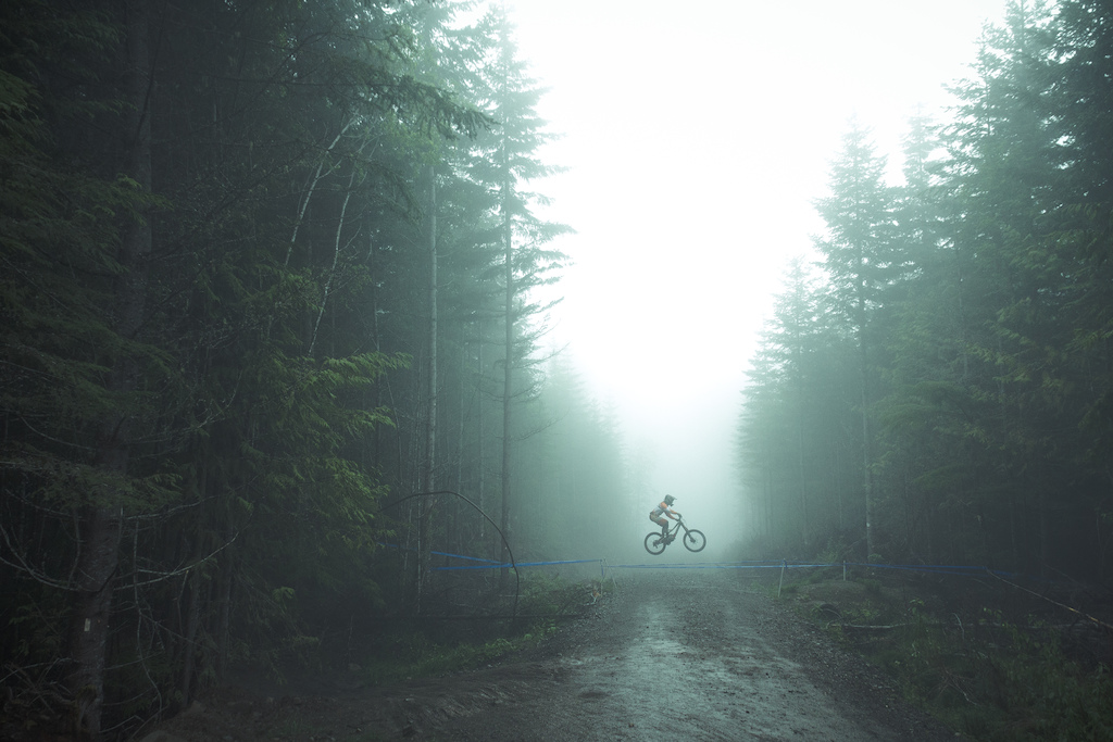 An unknown rider gaps the road in the mist on day two of the third Northwest Cup.