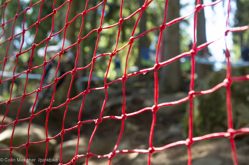 Hard to focus on Loic Bruni through the safety netting.