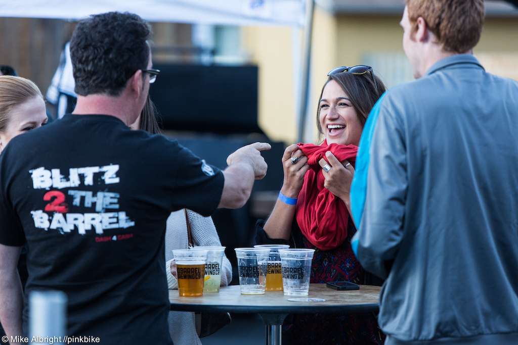 The Blitz to the Barrel race organizer, Erik Eastland (left), entertains local news anchorwoman Alicia Inns (right ) and crew before arm wrestling starts.