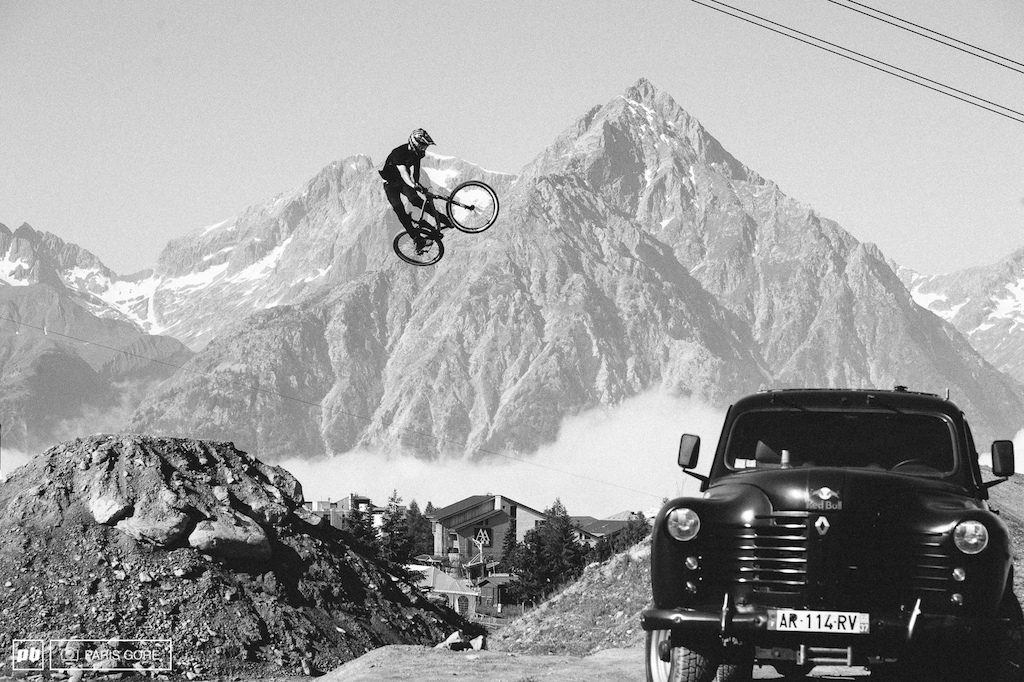 Brett Rheeder jumps the lower road gap and into the final jump. Mountains giving a not too terrible backdrop in Les 2 Alps.