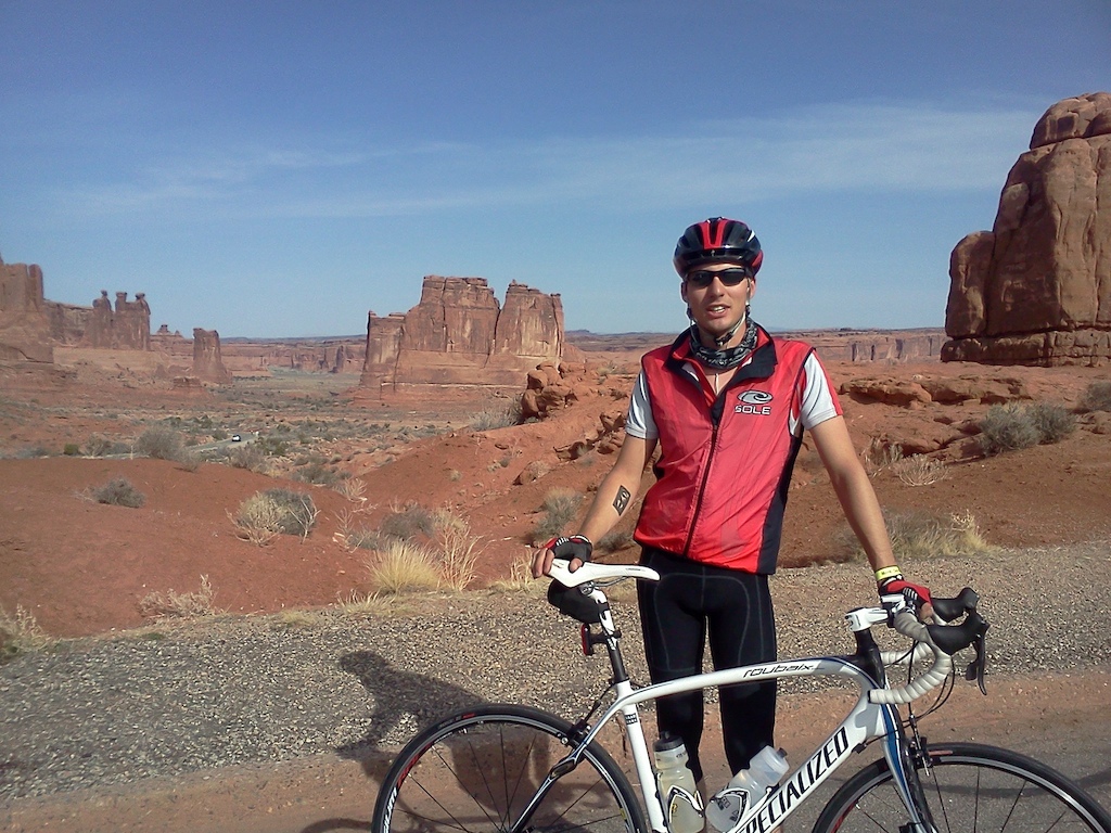 Arches road ride as part of the Skinny Tire Festival in Moab. Rad aid station, with Courthouse towers and the Three Gossips behind me!