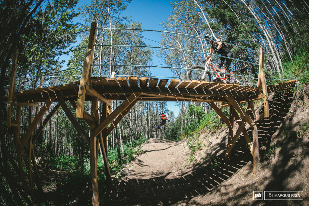 A perfect example of Kevin Eskelin s emphasis on user friendly trail intersections. Meg Broswick crosses while Andre Dube shows off his new whip skills after a week long trip to Whistler.