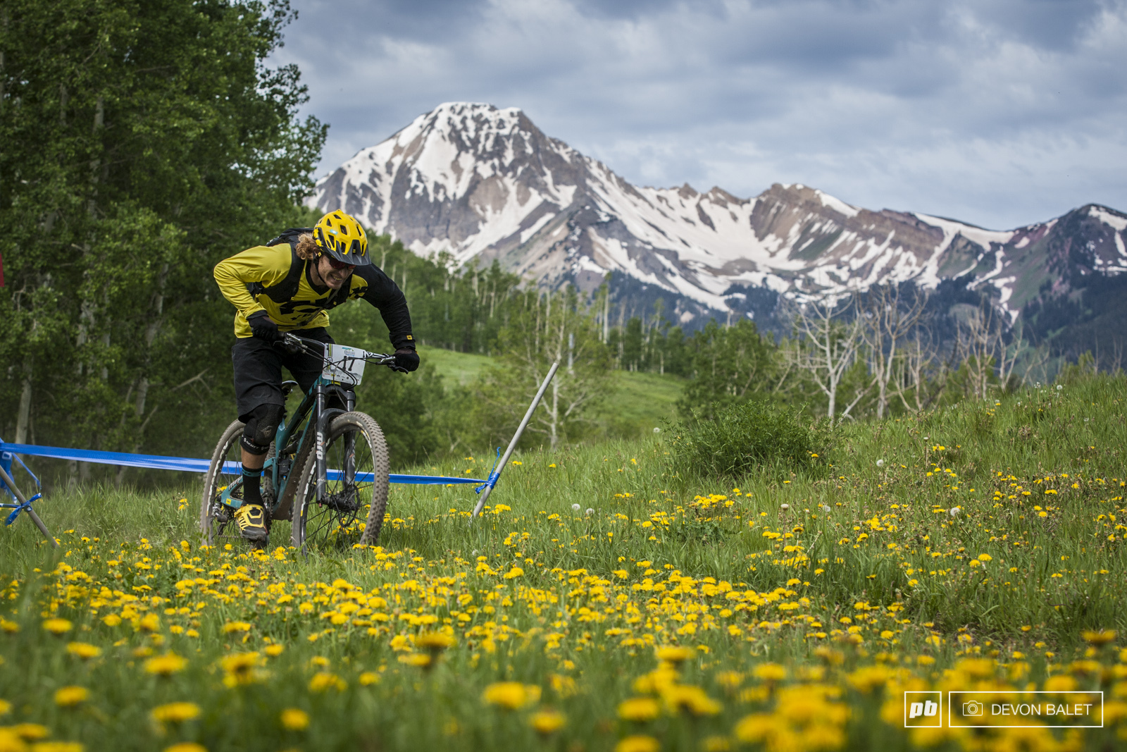 Stage one of racing sent racers into some incredibly scenic areas of Snowmass mountain. Alex Petitdemange grins as he hammers out a flat section, no time to enjoy the views!