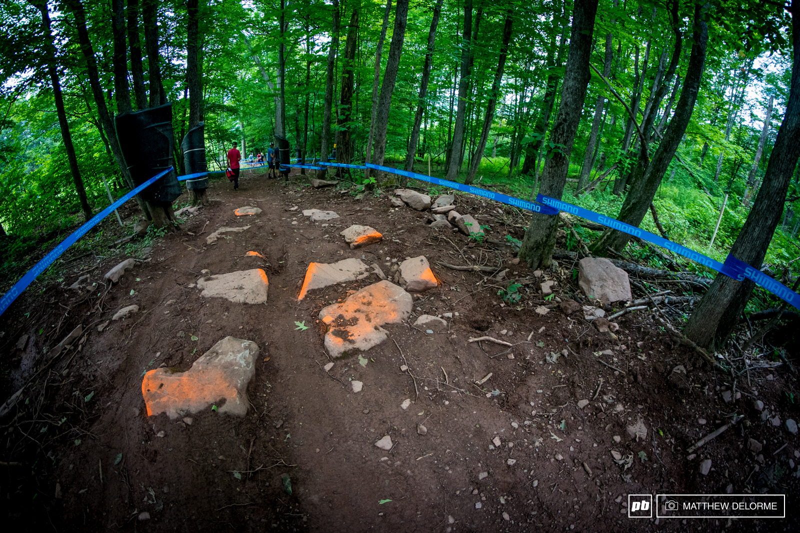 World Cup downhill tracks are supposed to be rough and technical, but it seems this year the track has been soothed out just a bit more. There may be about 12 cans of orange spray paint on the rocks.