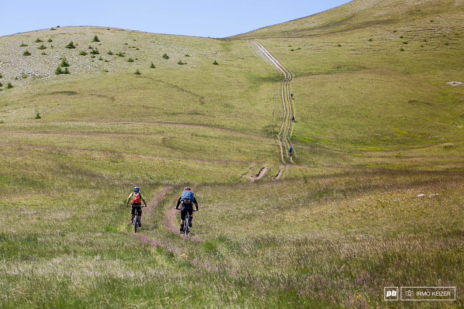Never make the mistake of thinking the climb is finished. Rounding the corner, these riders face another fierce uphill after hours of sustained climbing by bike and on foot.