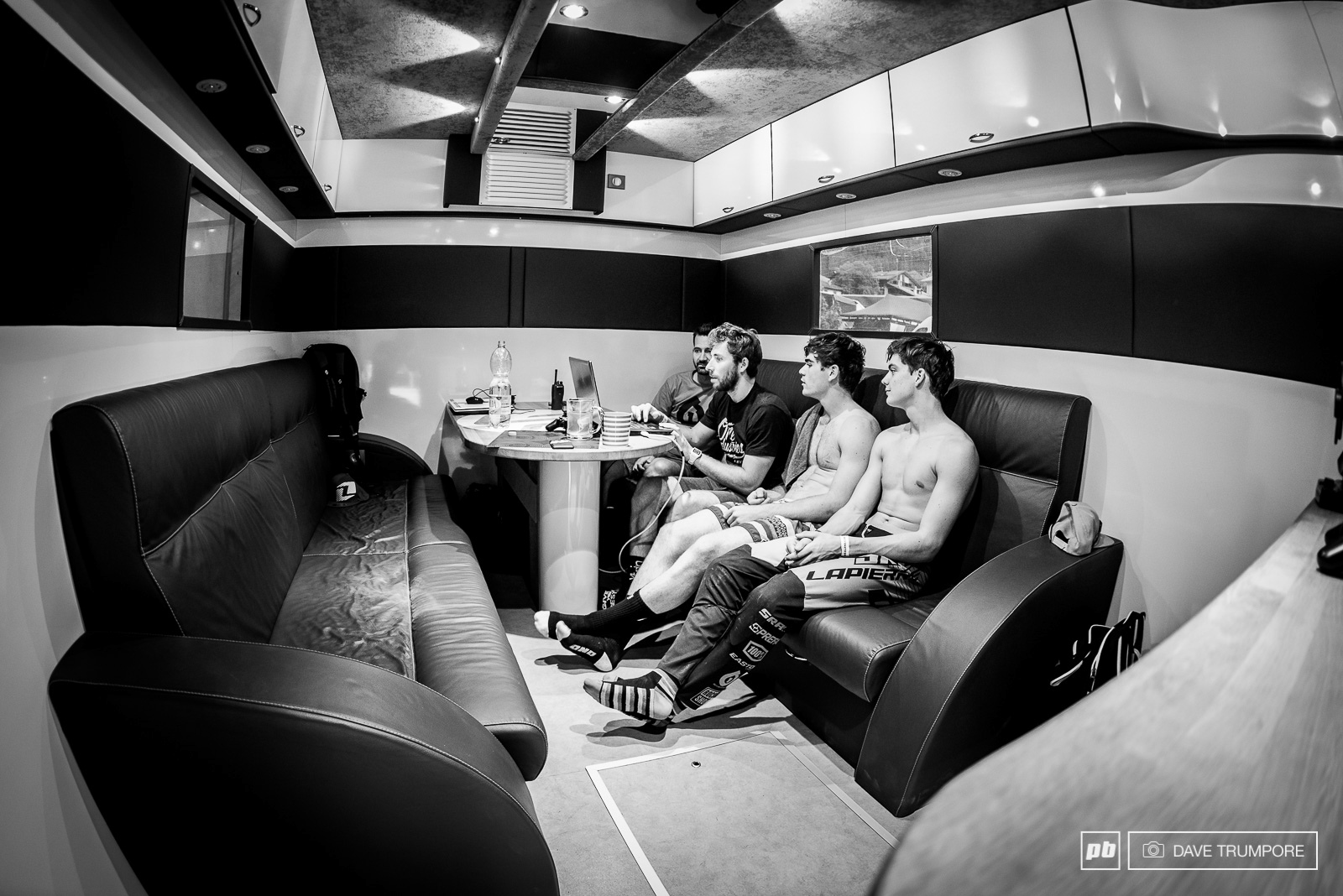 Team manager coach and riders reviewing helemt cam footage after practice in Val di Sole. It is very much a group effort for the Lapierre Gravity Republic.