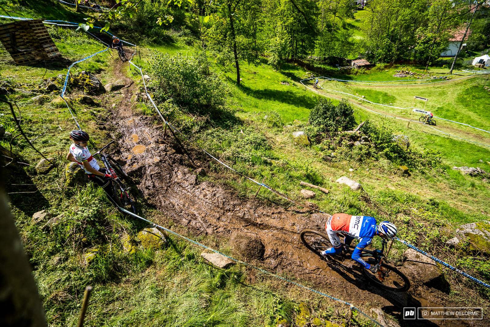 Maja looks on as the master of La Bresse skillfully navigates a mud river.