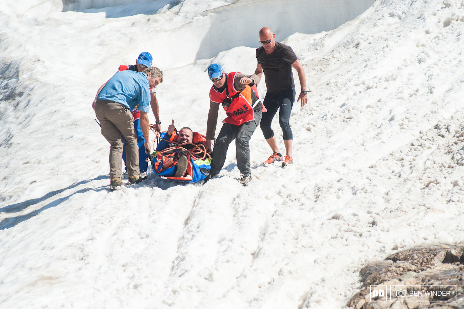 Thumbs up from this injured rider we re sure it s not the way he imagined getting down the mountain today.