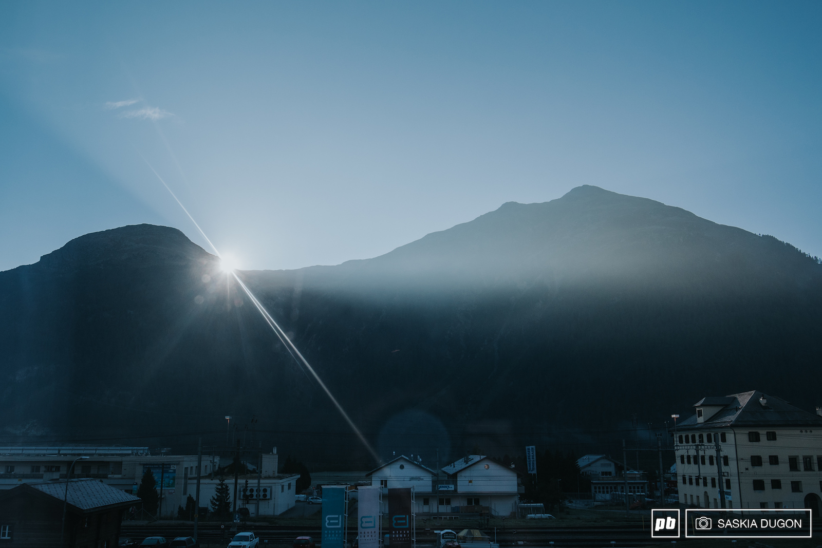 The sun peaking over mountains to wake the small town of Bever.